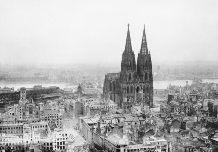 Dert Kölner Dom inmitten der Trümmer der zerbombten Stadt. Das Foto stand aus dem März 1945. Foto: © Clark (Mr), Royal Air Force official photographer / Public domain / via Wikimedia Commons (photograph CL 2169 comes from the collections of the Imperial War Museums)